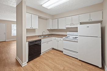 A kitchen with white appliances and cabinets.